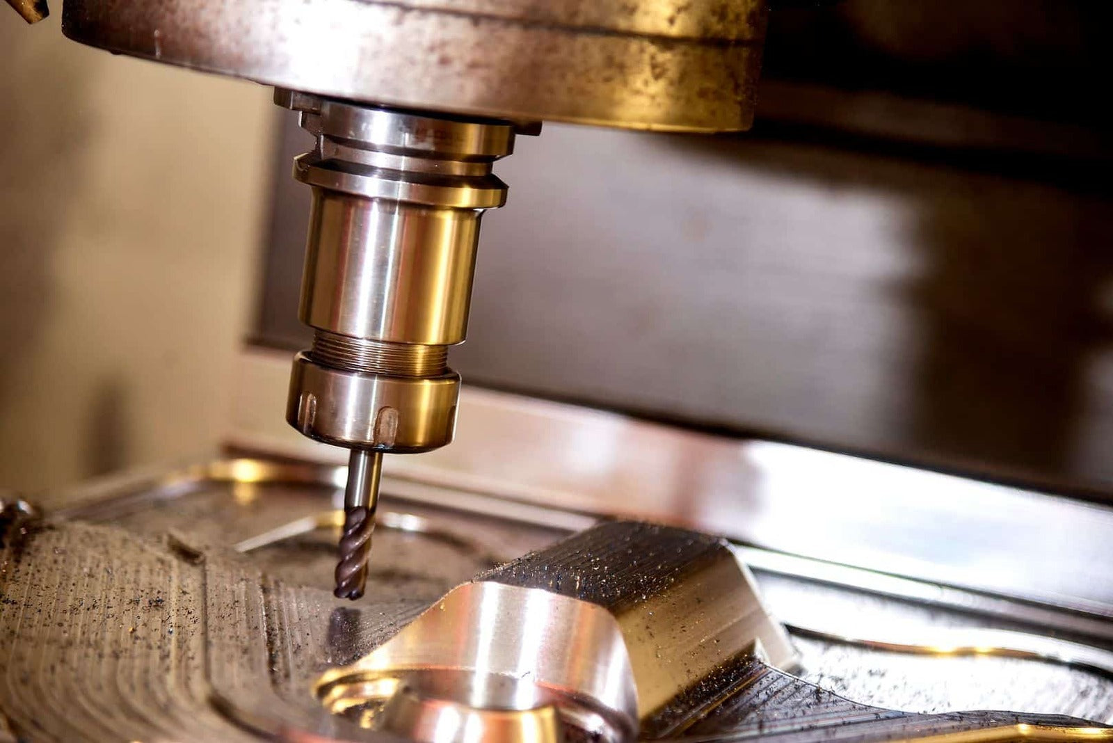 Precision CNC machine drilling metal component for manufacturing process.