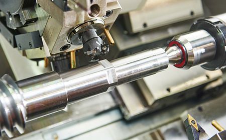 Precision CNC machining process with high-quality metal components on a manufacturing lathe.