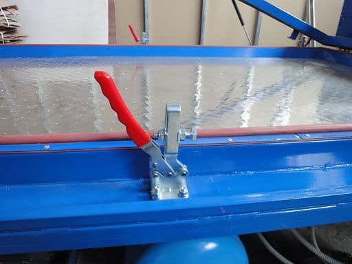 Durable blue industrial snow plow with red adjustable handle and metal mounting bracket for efficient snow removal tasks.