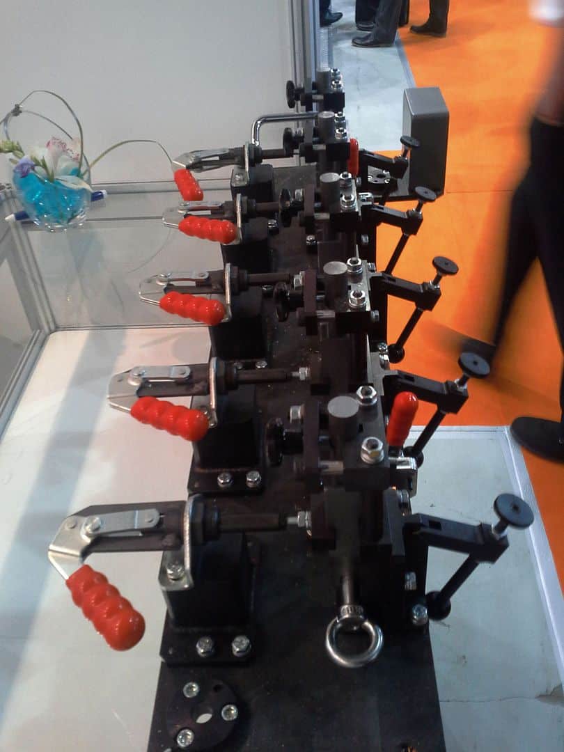 Precision industrial machinery with multiple clamps and levers for manufacturing applications.