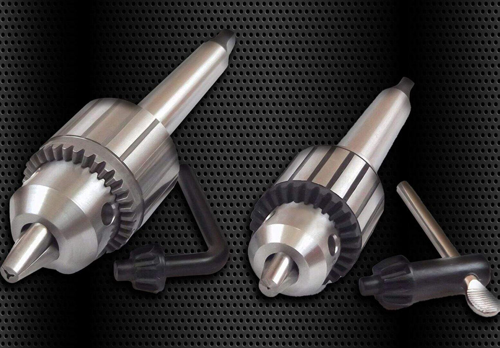 Machining tools and precision drill chucks on a black perforated metal background for industrial and manufacturing applications.