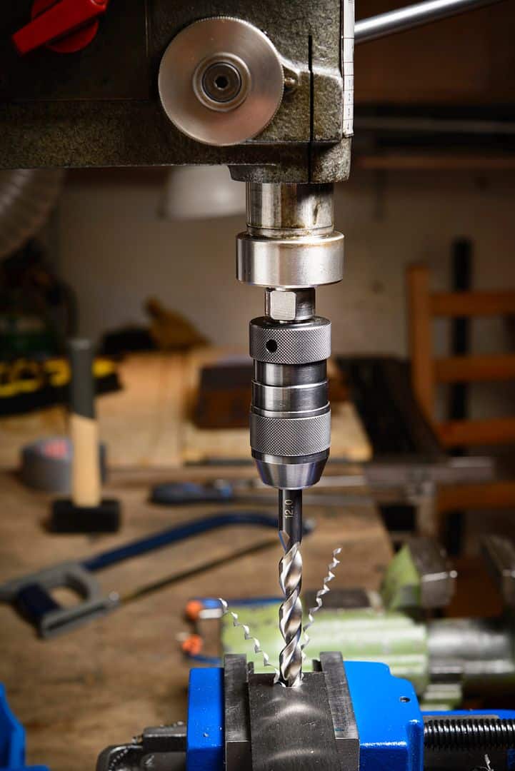 High-precision drill bit in a CNC machine workshop for manufacturing tools and hardware applications.