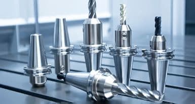 Precision metal cutting tools displayed on a worktable for manufacturing and machining CNC projects, showcasing high-quality industrial tooling for precision engineering.