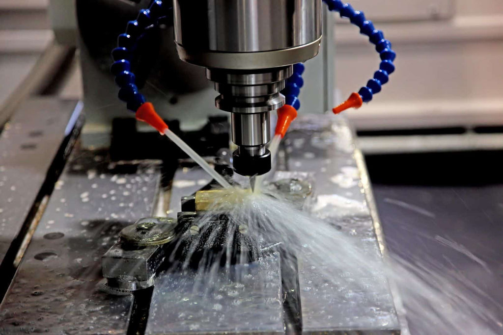 High-precision CNC machining process with coolant fluid cooling metal component on industrial machine.
