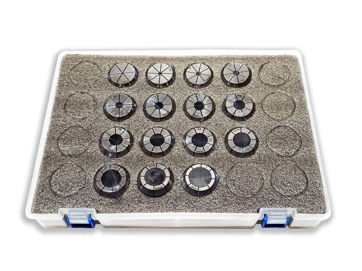 Precision dial indicator gauges for industrial measurement and calibration tools, stored in a foam-lined plastic case.