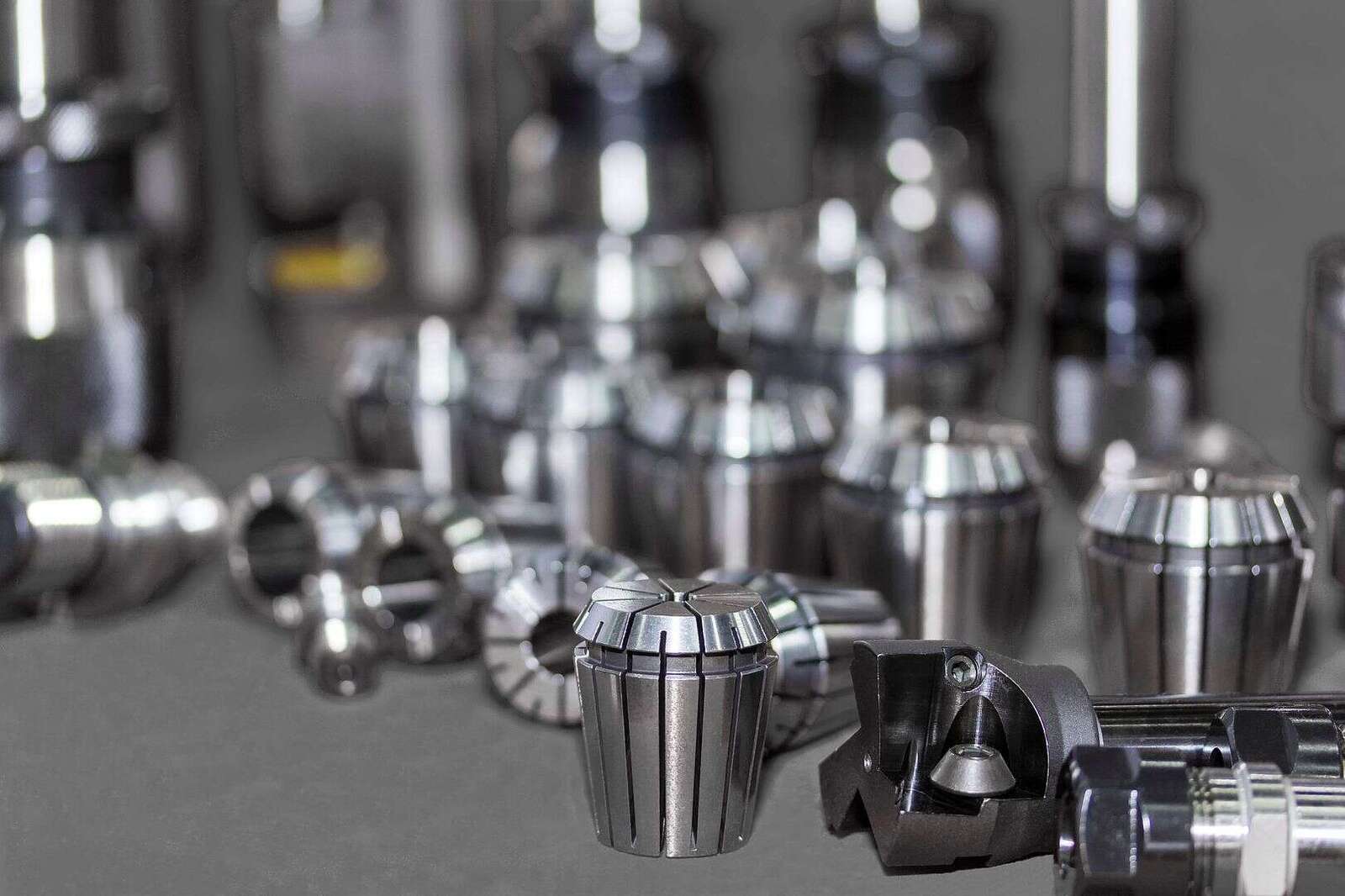 Precise CNC machine tool holders and cutting tools displayed on a workbench, showcasing high-quality industrial components for machining and manufacturing.